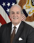 Smiling older man in suit with flags